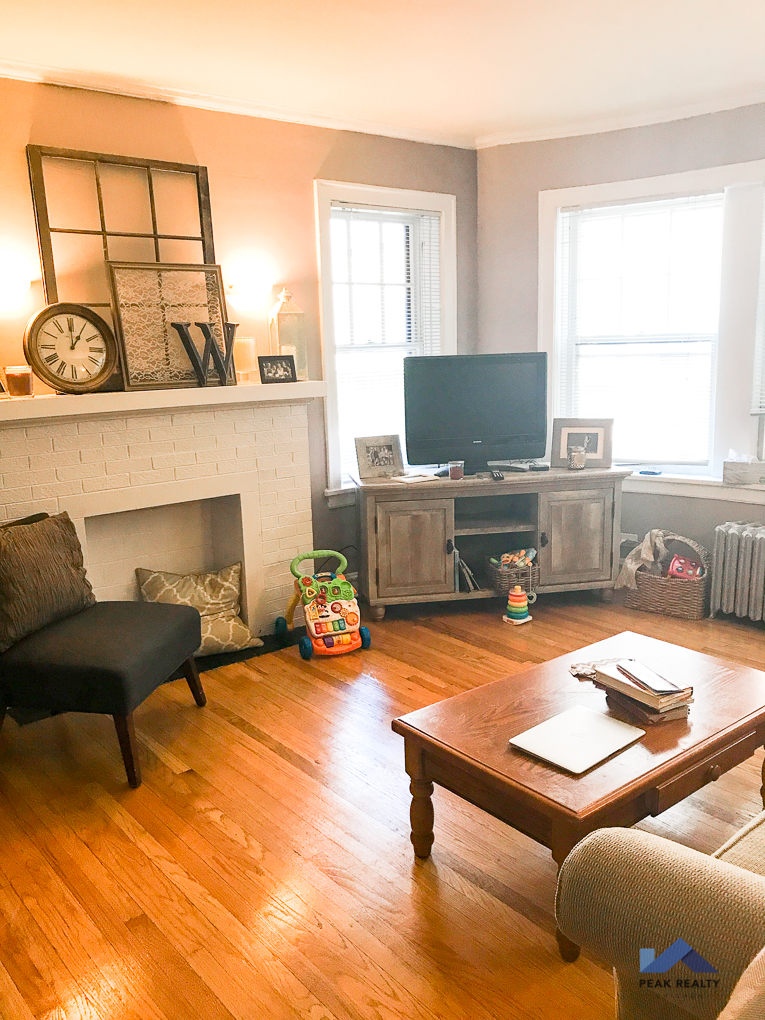 a living room with a fireplace and a television